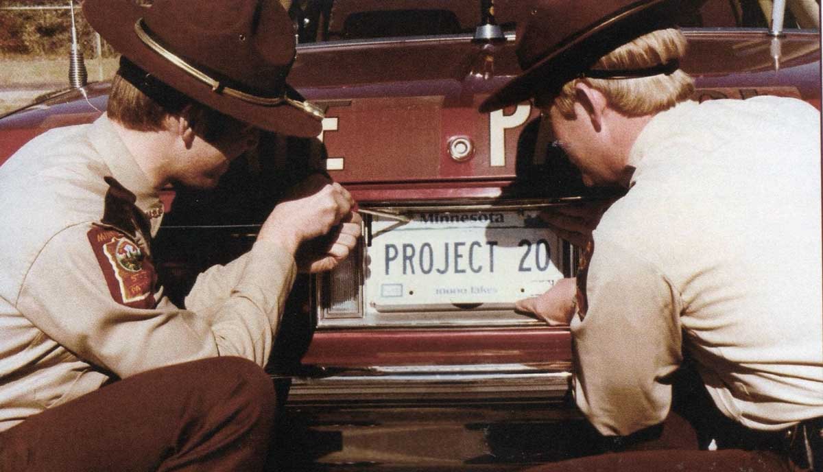 Minnesota police officers tacking off carplates